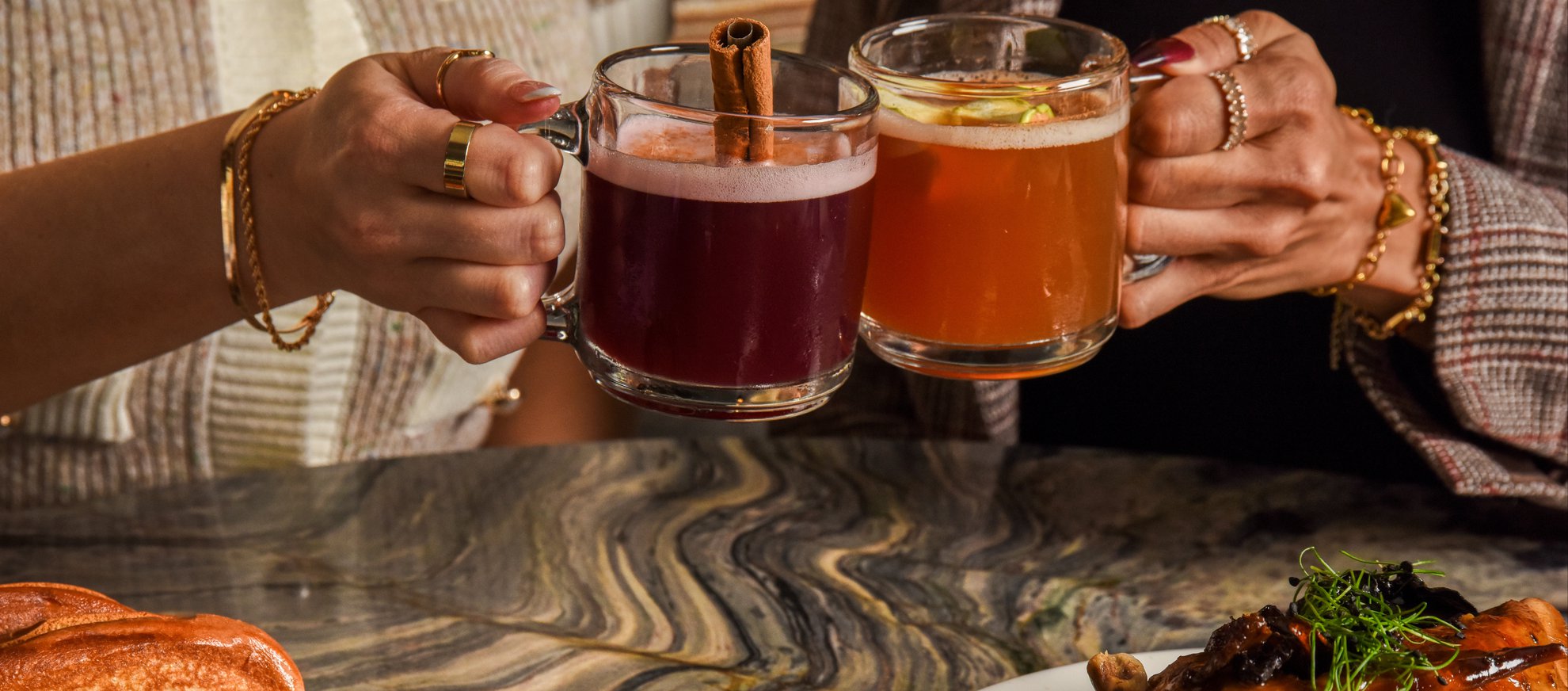 WEB RESIZE - Fora fall seasonal cocktail cheers of mulled wine with cinnamon straw and spiked warm cider over new fall entrees 9.25 landscape