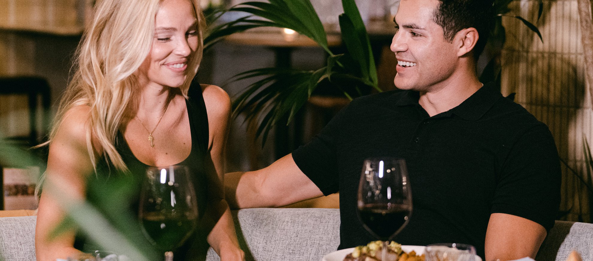a couple engage in the conversation at fora chicago with different dishes and red wine